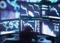 Illustration of man watching on monitors showing falling stock markets. Computer generated image.